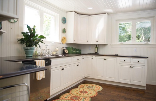 White cottage kitchen with beadboard and dark countertops