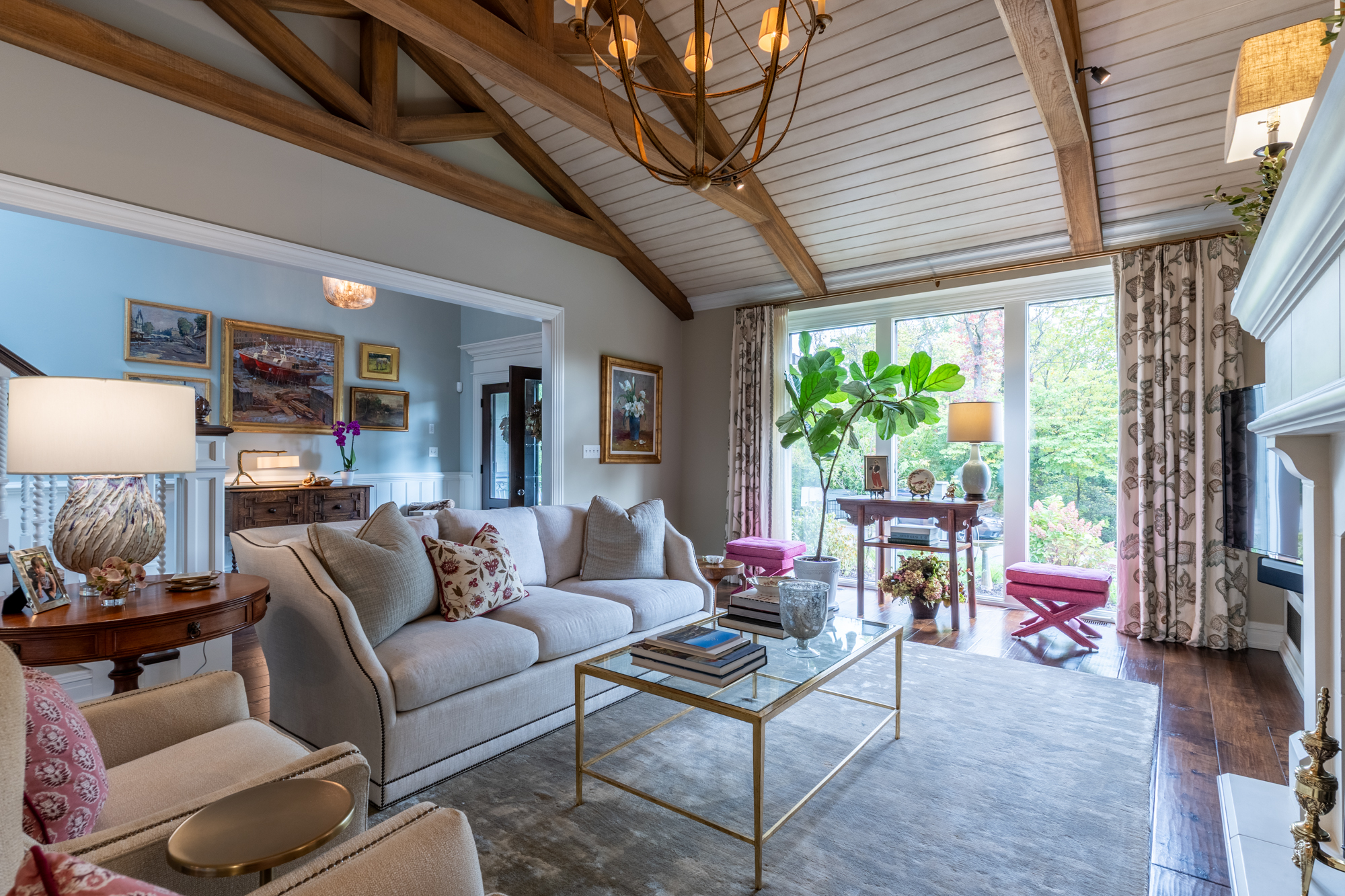Sunlit Mallard Cove living room with exposed beams and garden views